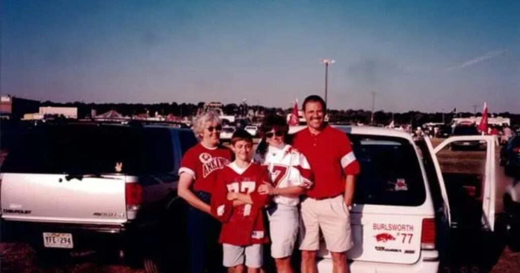 A family smiles together in front of a car, capturing a moment that reflects their early career achievements and memories.